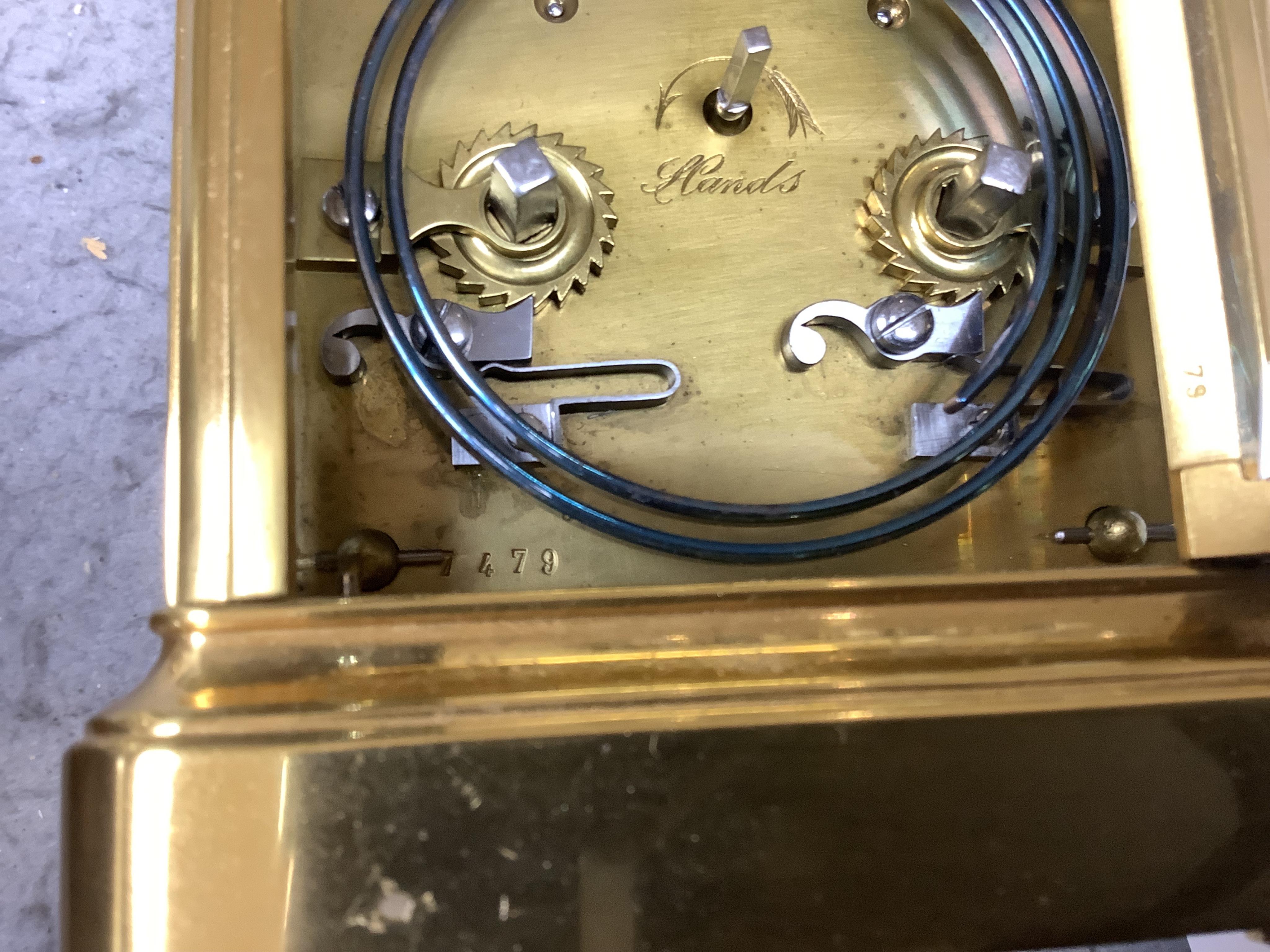 A cased unnamed brass carriage clock, 14cm tall. Condition - fair